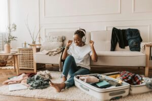 woman packing for her vacation after starting Invisalign near me + El Paso